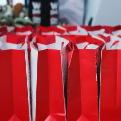 Viele rote Geschenktüten stehen bereit. Tolle Adventskalender Kolleg*innen Ideen für die Vorweihnachtszeit!