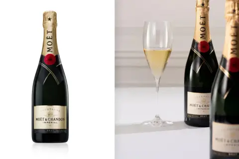 Zwei Flaschen Moët & Chandon Champagner, der beste Champagner der Welt, neben einem Glas prickelnden Champagners.