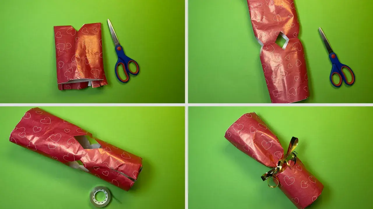 Schritt-für-Schritt-Anleitung: eine Kerze als Geschenk verpacken. Rotes Herz-Geschenkpapier wird zugeschnitten, gefaltet und mit Klebeband fixiert.